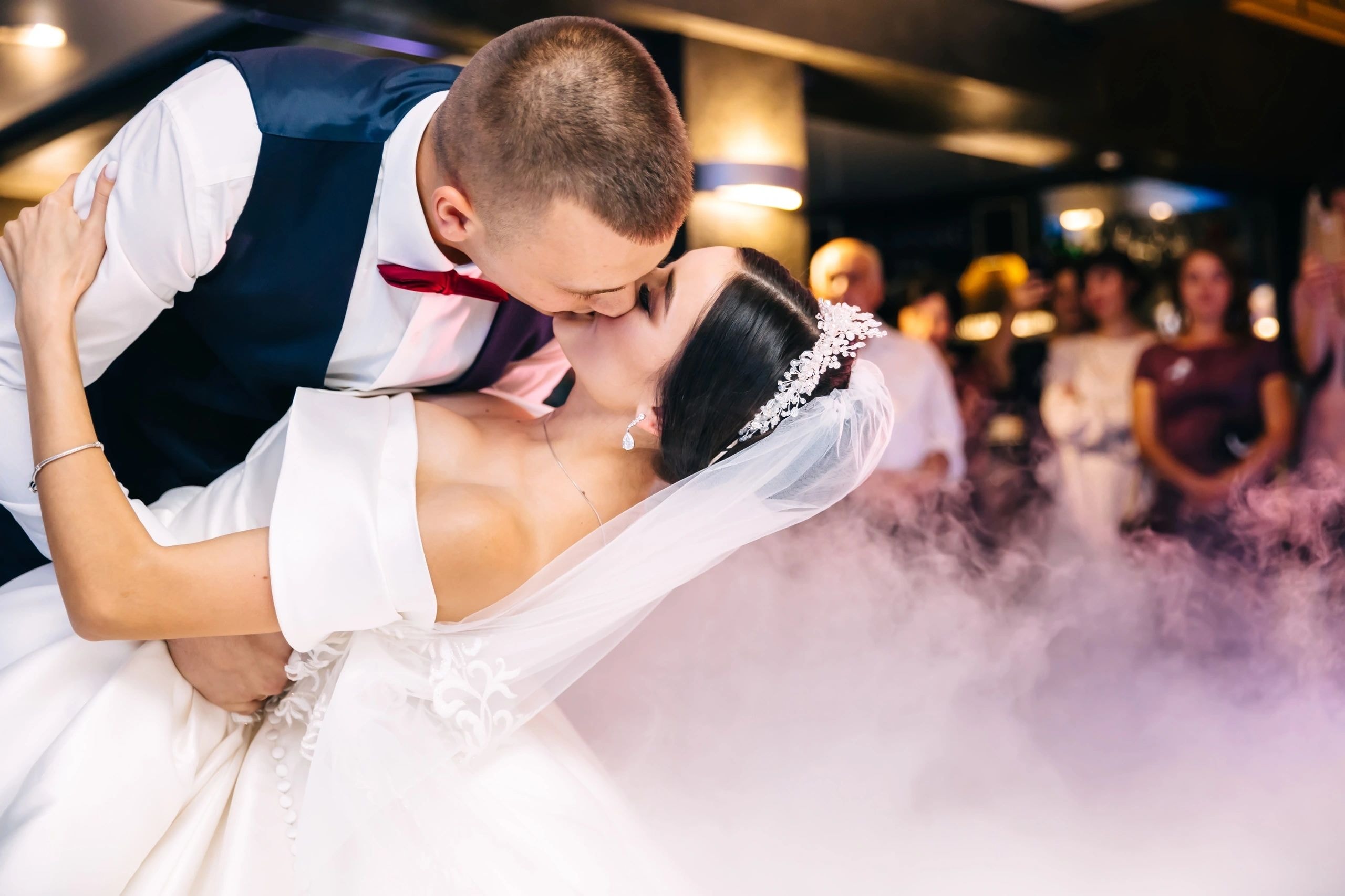 Couple performing a graceful dip during their wedding dance lesson